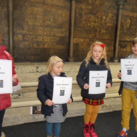 The children line up in order of the ranks of the Royal Navy held by Cloudesley Shovell.