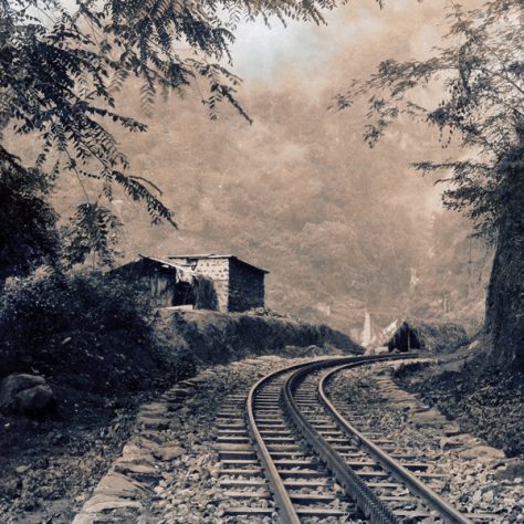 A railway line goes through mountainous territory.